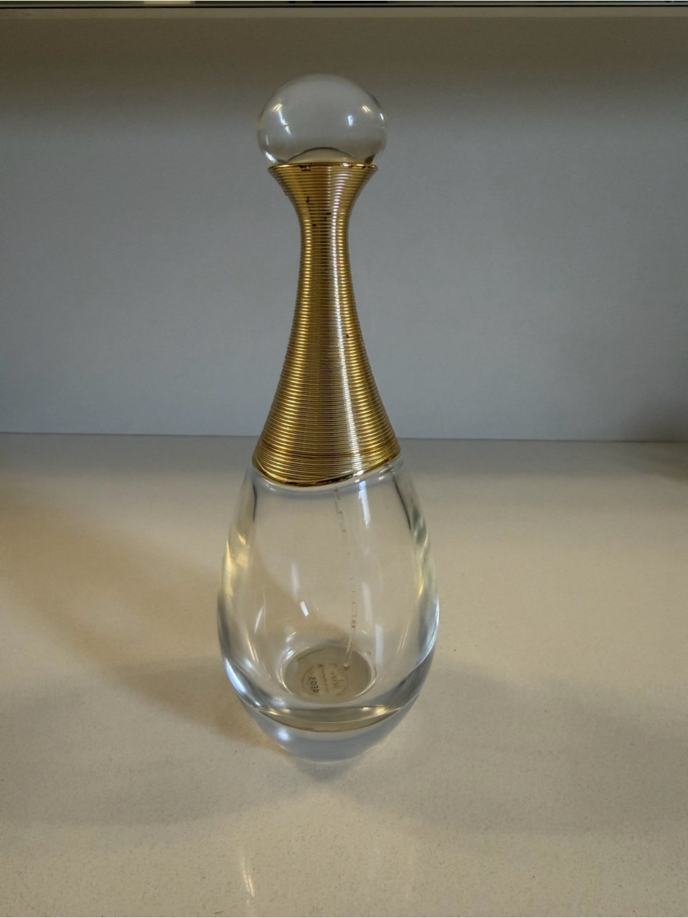 Empty J’Adore Dior perfume bottle